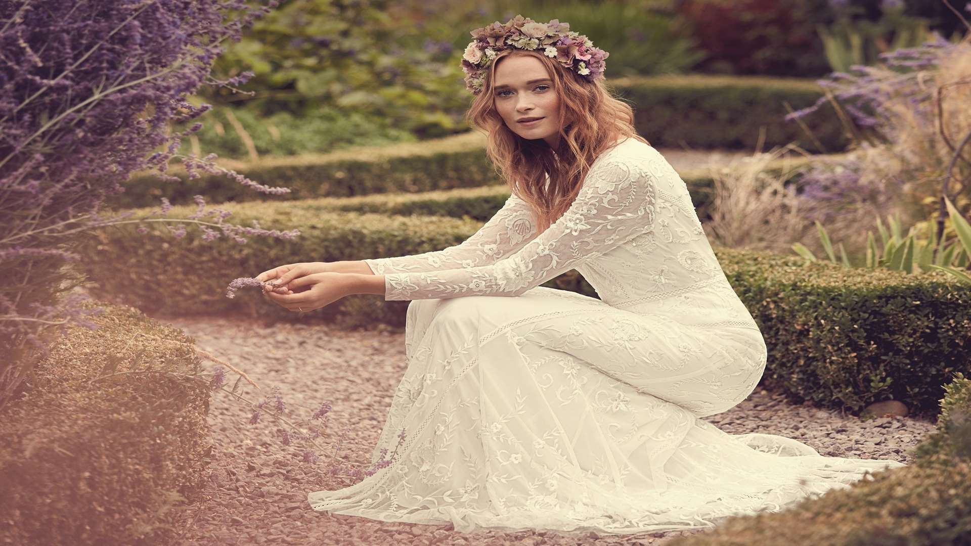 An ivory Eligenza lace bridal dress by Savannah Miller. Available from debenhams.com